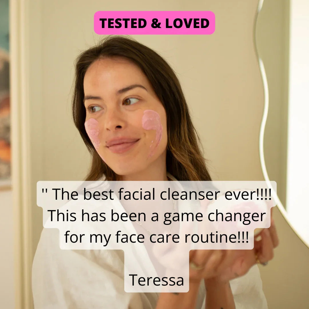 Woman applying pink facial cleanser, testimonial: 'best facial cleanser ever' — eco-friendly, low-tox face care