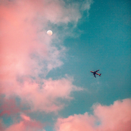 Plane in the sky with pink clouds. Dust&Glow Powders, ditch the liquid and switch to powder based beauty 